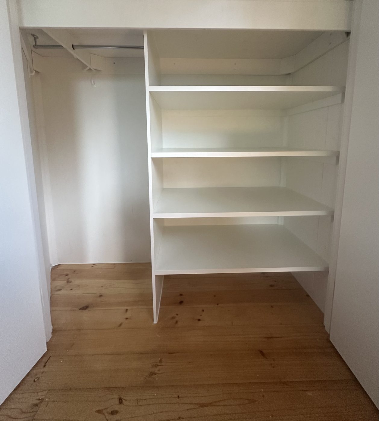 Built-in wardrobe with a hanging rail and full-height shelving